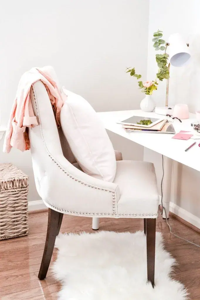 Bright home office with a pink throw over a white chair