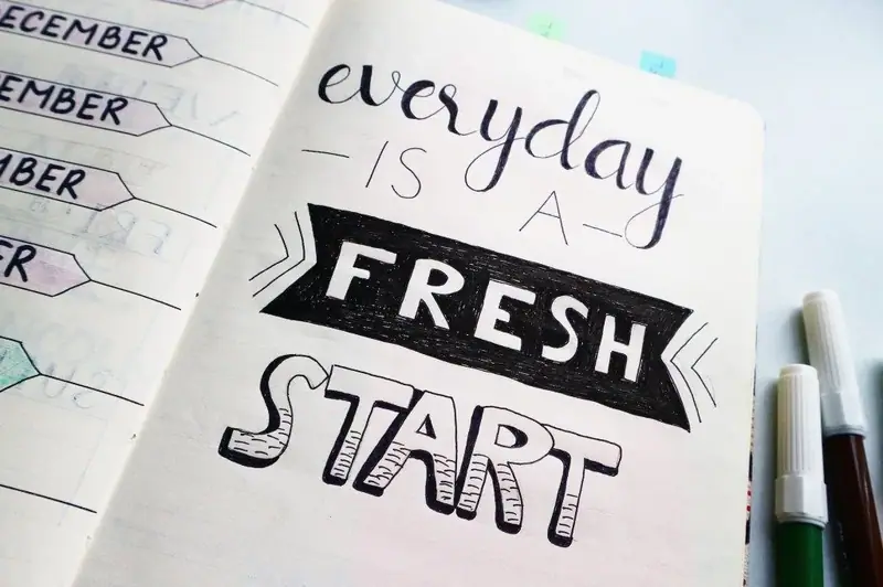 Open notebook reading “Everyday is a fresh start”