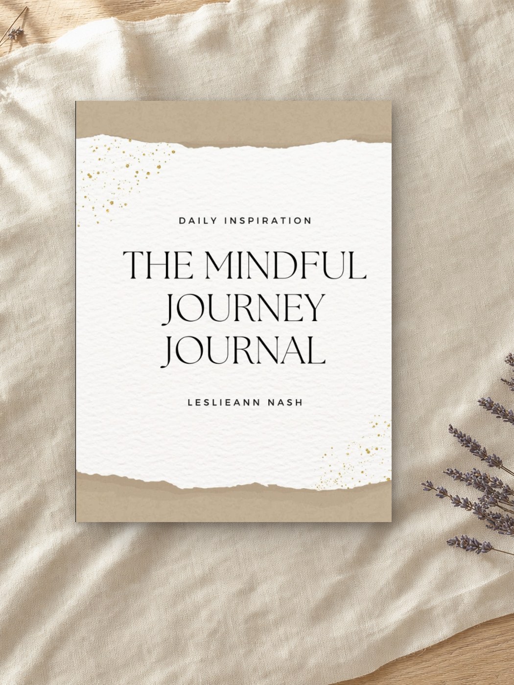 The Mindful Journey Journal by Leslieann, its torn-paper cover with gold flecks resting on cream linen beside dried lavender