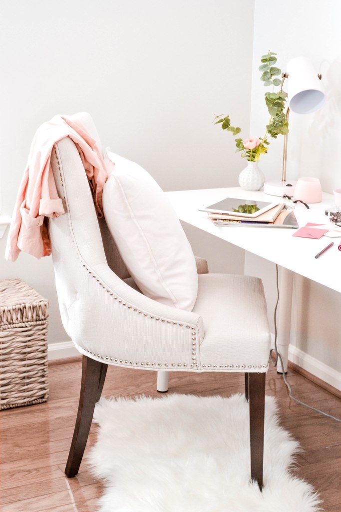 Bright home office with a pink throw over a white chair