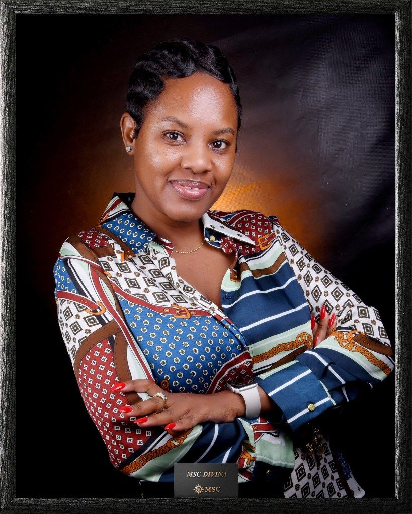 Portrait of a woman in a patterned blouse with folded arms