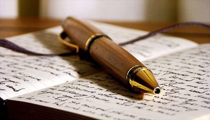 Fountain pen resting on handwritten notes